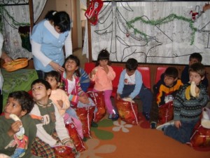 Abandoned children enjoying the Christmas presents and the fruits.